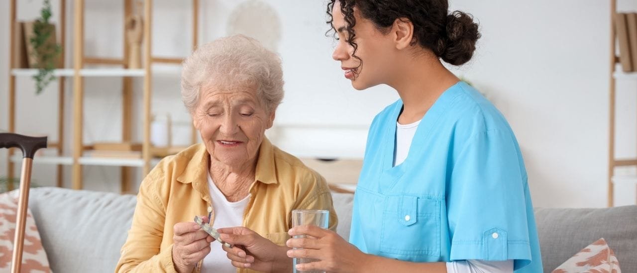 Care assistant helping with household tasks to maintain a clean and safe home.