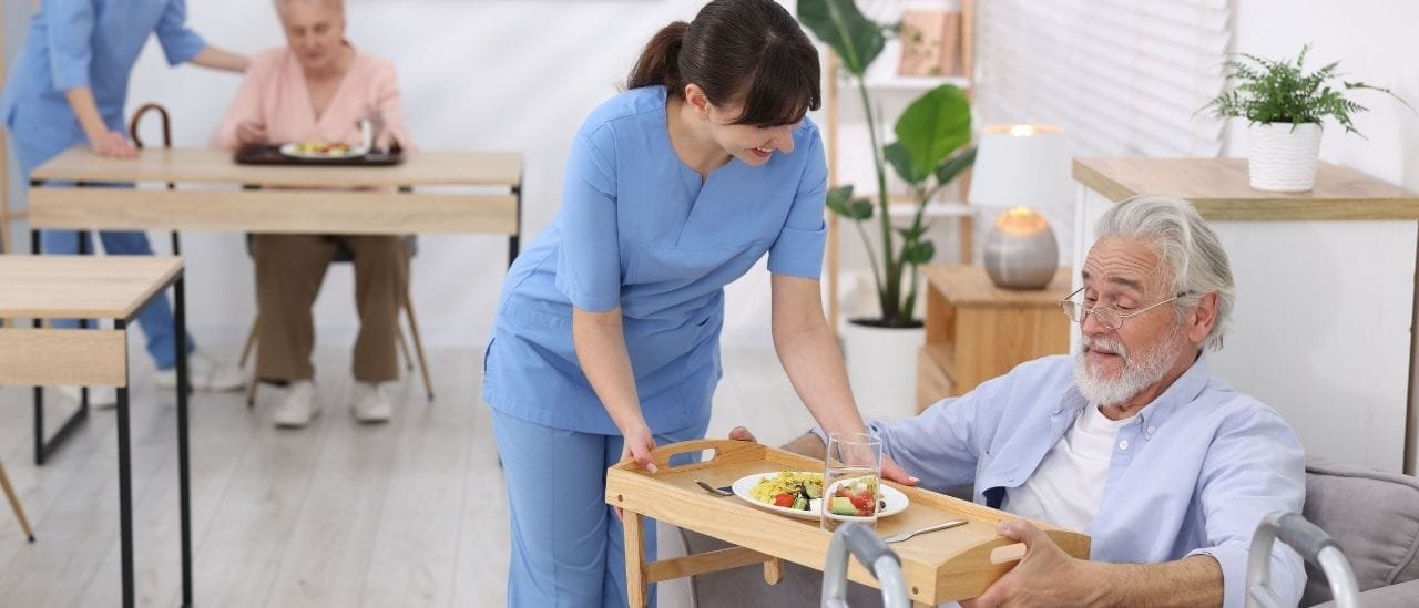 Live-in carer providing continuous support to an elderly client in a comfortable home.